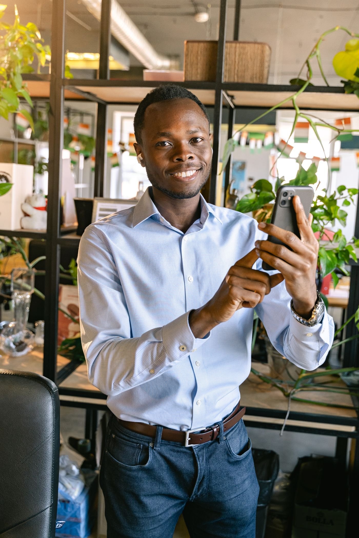 Smiling KD Tips member checking an update on his phone
